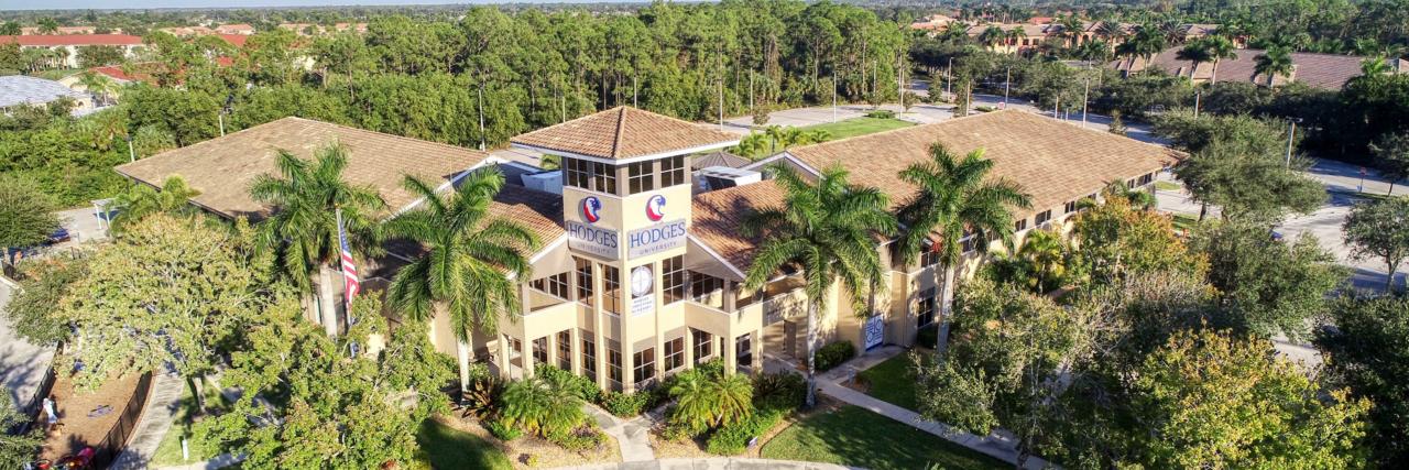 Bird eye view of Hodges University building, blue skies and trees around the facility