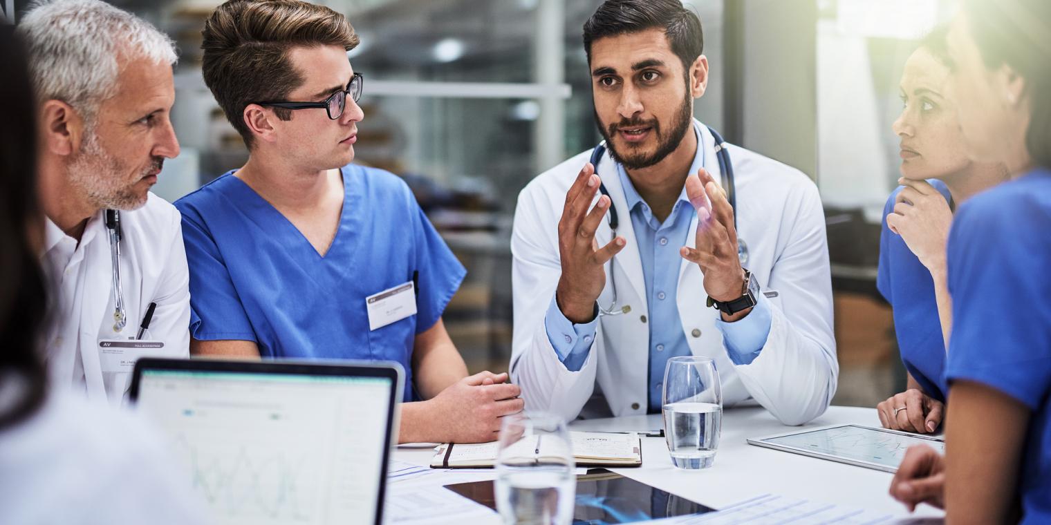 group of doctor's having a meeting around a table